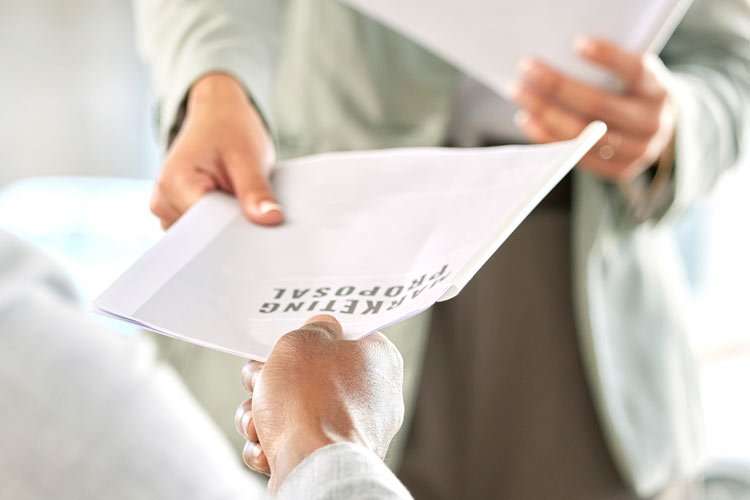 Handing paper report to another hand